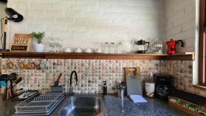 a kitchen with a sink and a counter top at Premium Holiday Cabin - spectacular Tungurahua volcano view in Baños