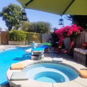 a large swimming pool with a table and a patio at Cool Casual Living A/C,Non-Smoking, 25+ and over in Lakewood