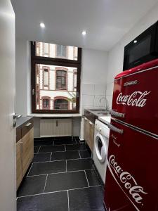 een keuken met een cocacola koelkast en een raam bij Ganze Wohnung Wiesbaden Stadtmitte 2 Zimmer Küche Bad mieten in Wiesbaden