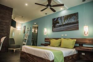 a bedroom with a bed and a ceiling fan at Bahia del Sol Beach front Boutique Hotel in Potrero
