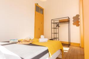 a bedroom with a bed with towels on it at GrowIN Digital Nomads in Faro