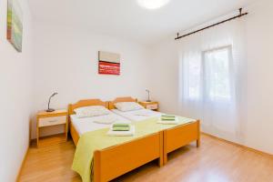 a bedroom with a bed and a table in it at Apartments with a parking space Milna, Brac - 11088 in Milna