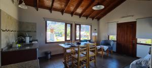a kitchen and dining room with a table and chairs at Kuntur Apart in El Chalten