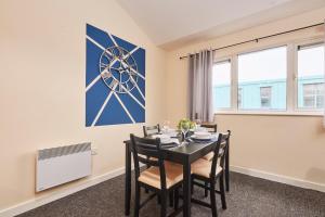 a dining room with a black table and chairs at Large 2 Bed in Central Coventry - Sleeps 6 - Parking in Coventry