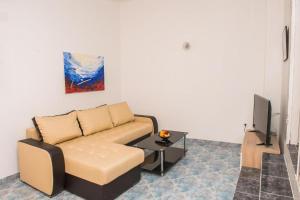 ein Wohnzimmer mit einem Sofa und einem TV in der Unterkunft Family friendly house with a swimming pool Cista Velika, Vodice - 20227 in Velika Čista