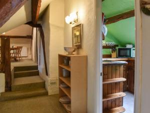 a kitchen with a staircase and green ceilings at The Loft - Ukc6139 in Cartmel