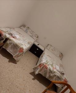 A bed or beds in a room at Hostal “ INFANTAS”