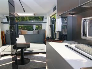 a kitchen and living room of an rv at Dreamer luxury caravan on the backwaters, Lütow in Lütow