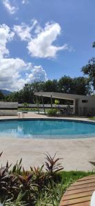 a swimming pool in the middle of a yard at Apartment near to Bello Horizonte Beach, Santa Marta Airport in Santa Marta