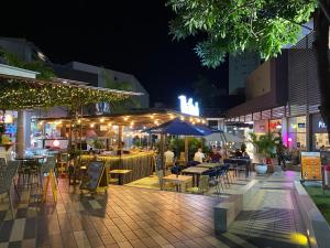 a patio with tables and chairs and lights at night at Apartment near to Bello Horizonte Beach, Santa Marta Airport in Santa Marta