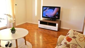 a living room with a flat screen tv on a stand at Apartment Karmen in Šilo