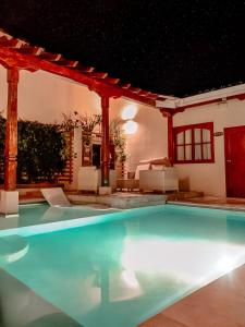 a swimming pool in a house at night at Hotel la Perla Leon in León