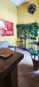 a living room with a table with a plant on it at Sol de Iracema centro in Fortaleza