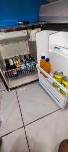 an open refrigerator filled with lots of food and drinks at Sol de Iracema centro in Fortaleza