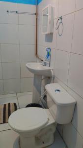 a bathroom with a toilet and a sink at Sol de Iracema centro in Fortaleza