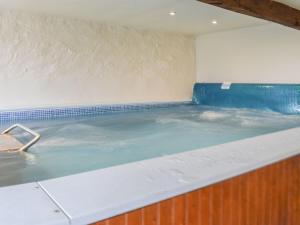 a large pool of water in a room at The Cottage - Ukc6140 in Cartmel