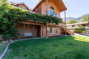 a house with a lawn in front of it at Epic View; A Luxury House on a Hill in Kernville