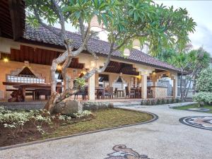 a building with a tree in front of it at Anda Amed Villas & Spa in Amed