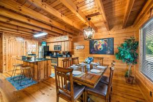 a dining room with a table and a kitchen at Bear Tracks in Gatlinburg