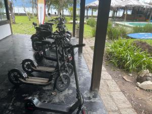 a row of motorcycles parked next to a pool at Pousada Lifestyle Ilhabela in Ilhabela