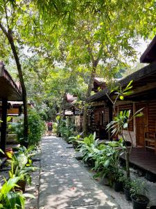 a walkway in front of a building with trees and plants at Samed sand sea resort in Ko Samed