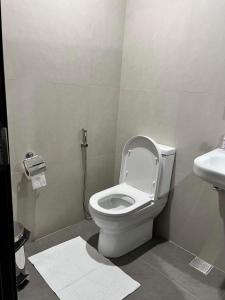 a bathroom with a toilet and a sink at Aeon Tower 2627 in Davao City +6 photos