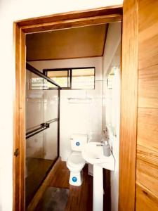 a bathroom with a toilet and a sink at CASA NOIL, Beautiful Eco House near the beach! in Puerto Viejo
