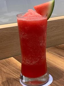 a glass of red drink with a slice of watermelon at Scarlett Resorts-Pangasinan, Philippines in Bugallon