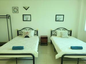 duas camas num quarto com duas almofadas em Yana House Phnom Penh em Phnom Penh