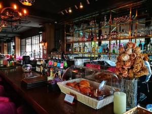 a bar with a counter with bread and pastries at VANHSENG BOUTIQUE VIENTIANE HOTEL in Vientiane