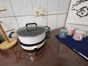 a large pot sitting on a table in a kitchen at 一起-台南 雙人套房 in Tainan