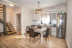 a kitchen with a table and chairs and a refrigerator at Villa RELAX in Tsoukalades +37 photos