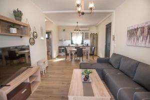 a living room with a couch and a table at Villa RELAX in Tsoukalades