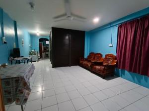 a living room with a couch and a table at Homestay Koperasi Surau Alfalah in Semporna