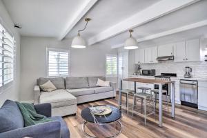 a living room with a couch and a table at Less Than 1 Mi to El Paseo Cottage Oasis with Fire Pit in Palm Desert