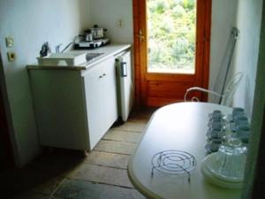 a kitchen with a table with cups on it at Pantheon Studios & Apartments in Limenaria