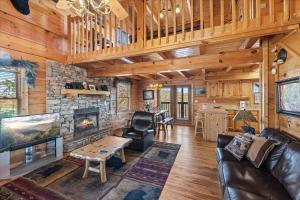a living room with a couch and a fireplace at Five-Bedroom House in Sevierville +29 photos