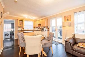a kitchen and living room with a table and chairs at Lovely and Modern Three Bedroom House in Durham in Durham