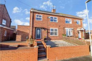 a brick house with a fence in front of it at Lovely and Modern Three Bedroom House in Durham in Durham