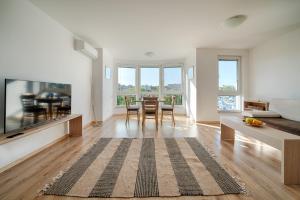 a living room with a couch and a table at Moana Fishermen Apartment in Ahtopol