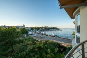 a view of a river from a balcony of a building at Moana Fishermen Apartment in Ahtopol +11 photos