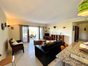 a living room with a couch and a table at Alvor Paradise With Pool by Homing in Alvor