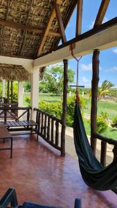 a porch with a hammock in a resort at SANJEELA-PLAGE COCO in Diego Suarez