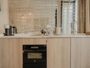 a kitchen with a sink and an oven at Comfy Studios in Benalmádena