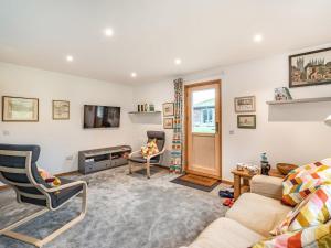 a living room with a couch and a fire place at Brindleshaw Barn in Meopham