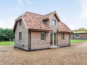 una pequeña casa de madera con techo naranja en Brindleshaw Barn, en Meopham