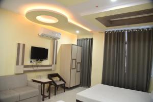 A television and/or entertainment centre at Hotel Shri Gourav