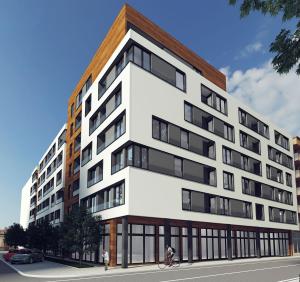 a person riding a bike in front of a building at Centar view lux in Novi Sad
