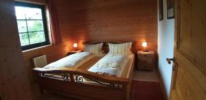 a bedroom with a bed with two pillows and a window at Berghaus Julia in Sankt Englmar