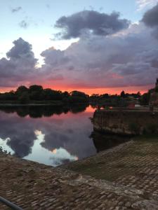 - une vue sur la rivière au coucher du soleil dans l'établissement Appartement Centre Historique, à Bergerac